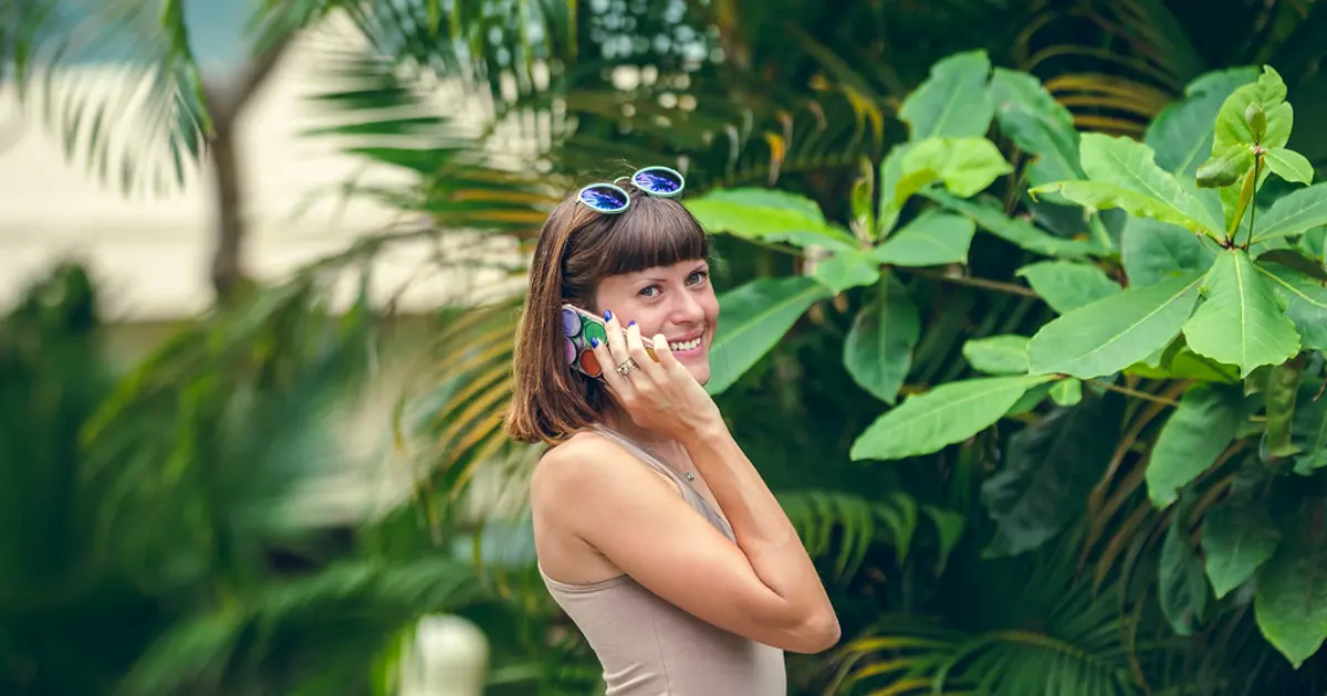 Traveler using a smartphone outdoors on a tropical trip