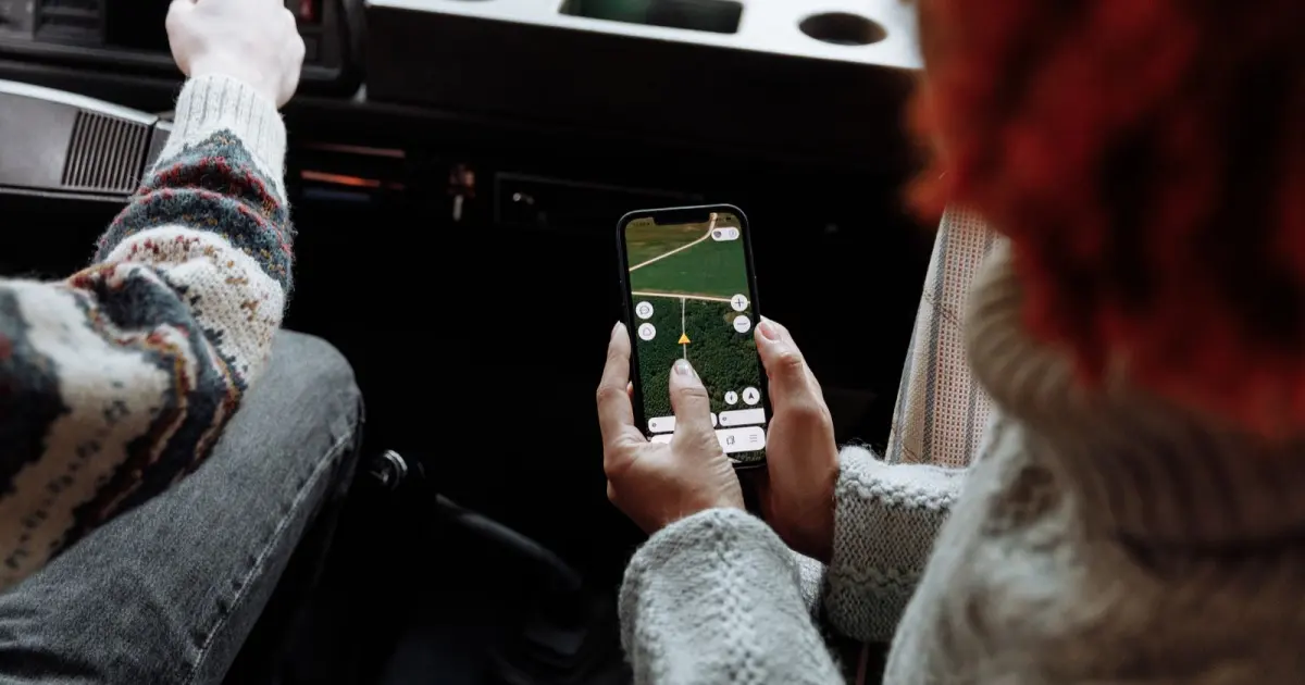 Travelers using a smartphone map to plan a multi-country route