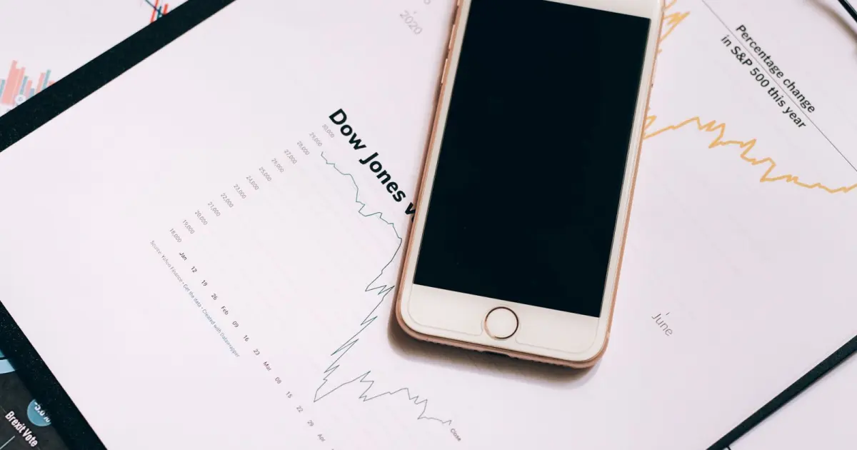 Smartphone beside printed charts representing plan limits and thresholds