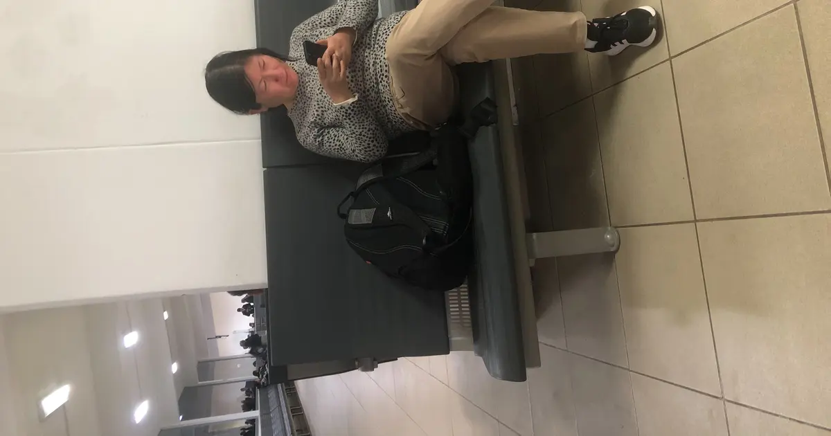 Traveler holding a smartphone while preparing an eSIM for a trip
